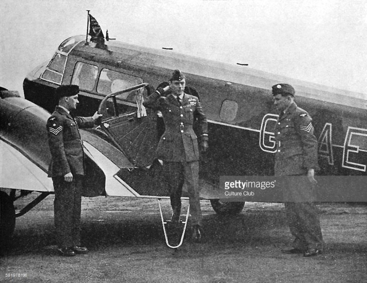 WW2 - King George VI disembarking from a plane at an R.A.F station.